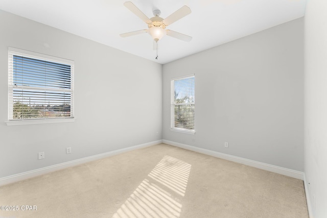 carpeted empty room featuring plenty of natural light and ceiling fan