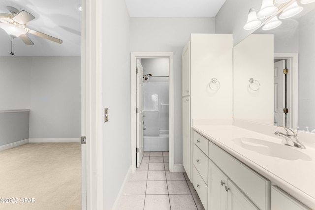 bathroom with tile patterned floors, vanity, ceiling fan, and tiled shower / bath