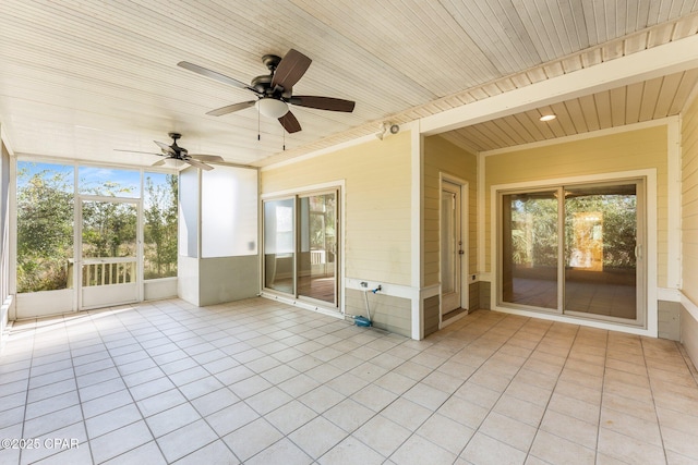 unfurnished sunroom featuring ceiling fan and wooden ceiling