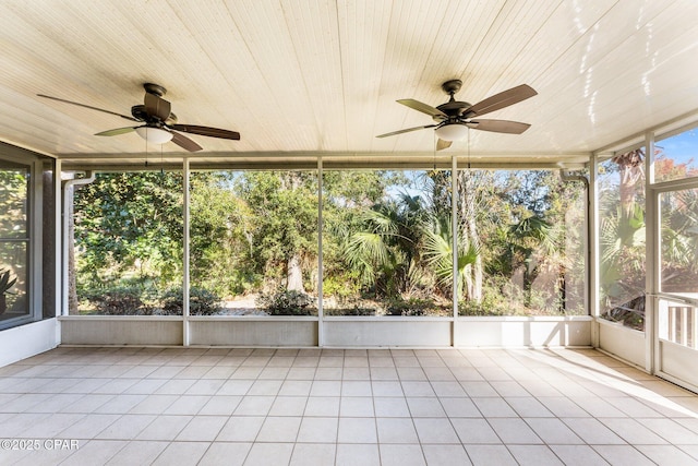 unfurnished sunroom with ceiling fan