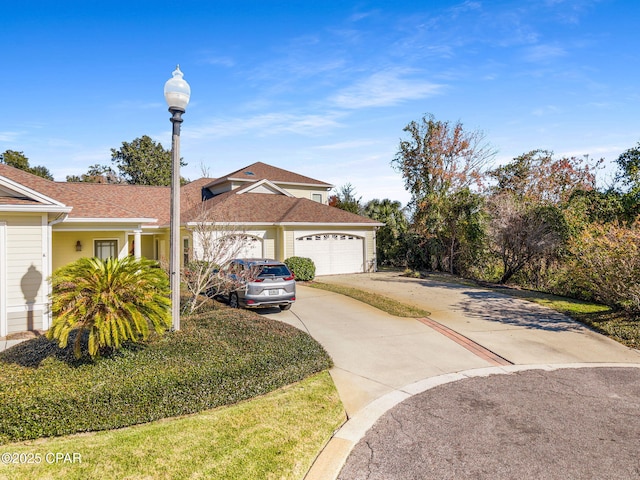 view of front of house with a front yard and a garage