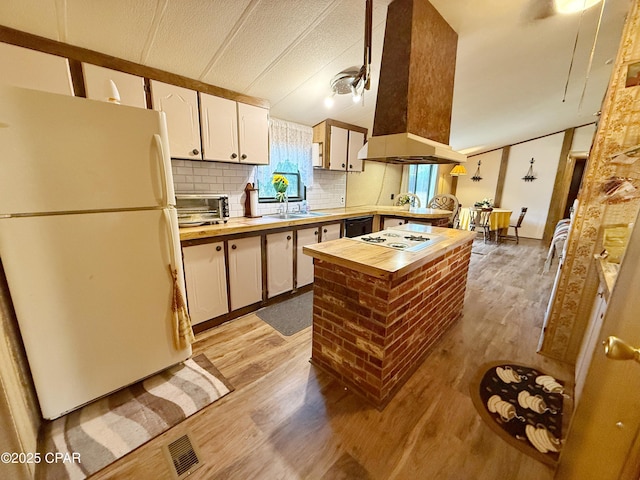 kitchen with custom exhaust hood, white appliances, light hardwood / wood-style flooring, white cabinetry, and butcher block counters