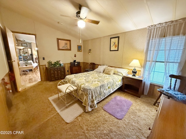 bedroom with ceiling fan, carpet floors, and vaulted ceiling