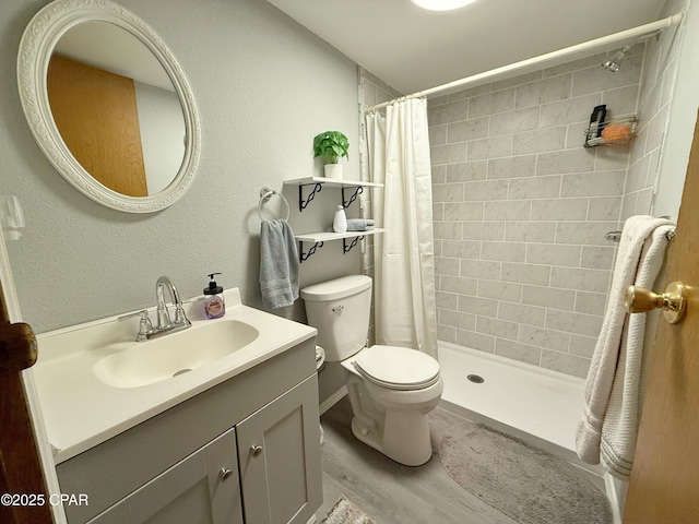 bathroom with vanity, hardwood / wood-style flooring, toilet, and curtained shower