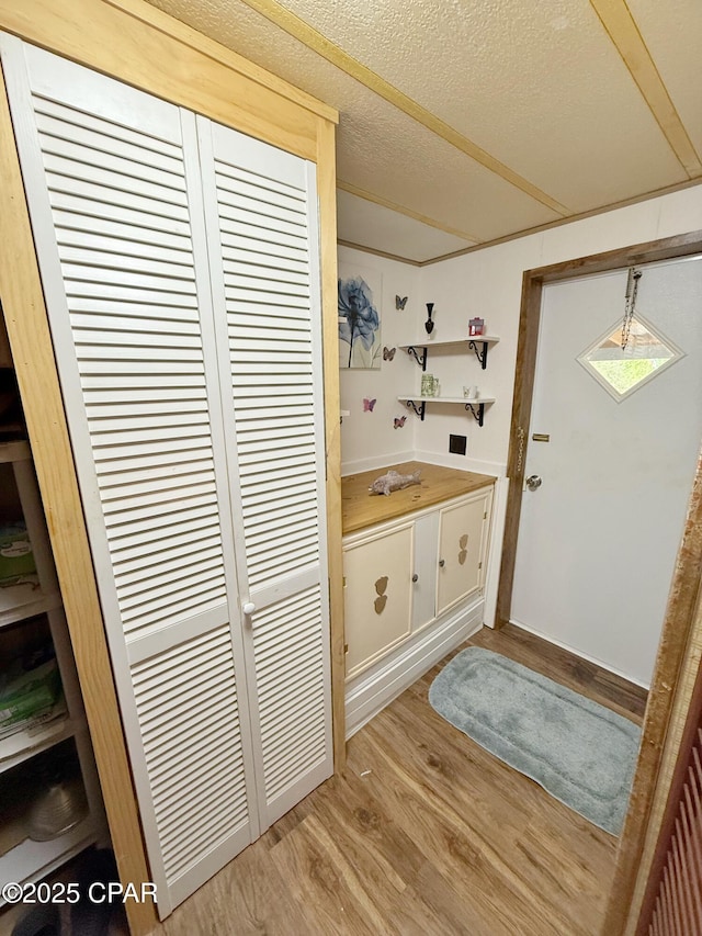 bathroom with vanity, wood-type flooring, and a textured ceiling