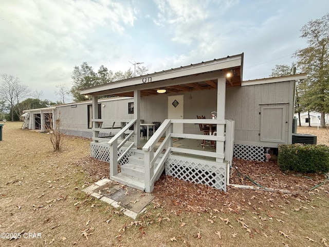 back of property featuring a porch