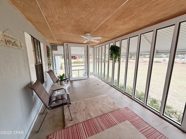 unfurnished sunroom featuring ceiling fan and wooden ceiling