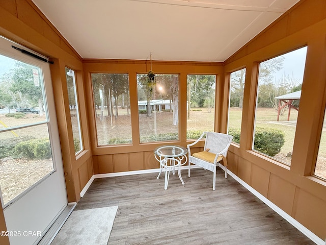 unfurnished sunroom featuring lofted ceiling