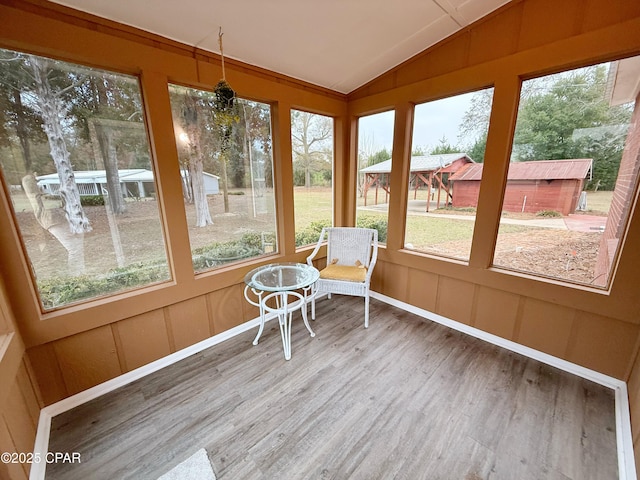 unfurnished sunroom featuring vaulted ceiling