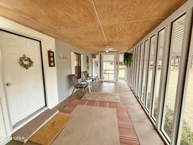 unfurnished sunroom featuring ceiling fan and wood ceiling