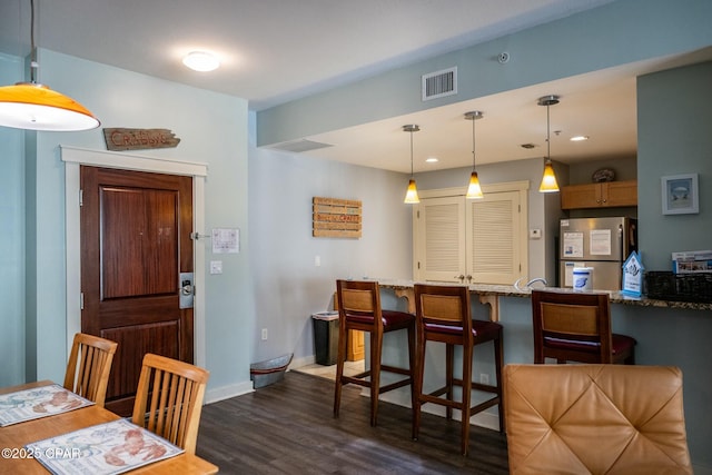 dining area featuring dark hardwood / wood-style flooring