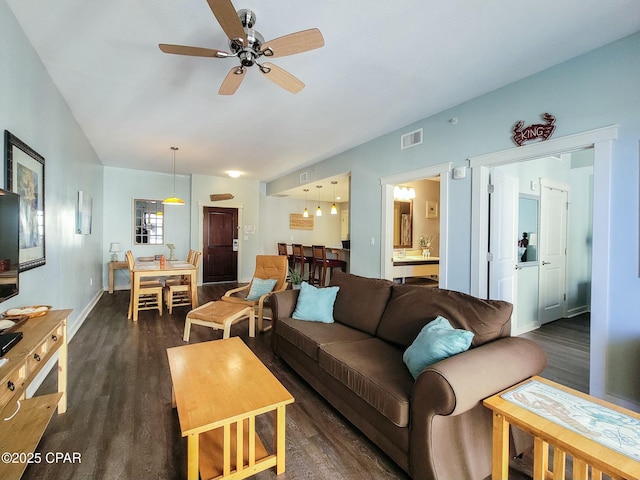 living room with ceiling fan and dark wood-type flooring