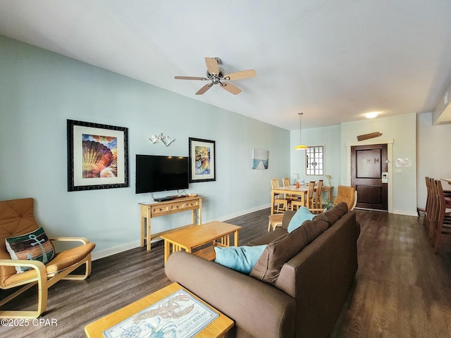 living room featuring dark hardwood / wood-style flooring and ceiling fan