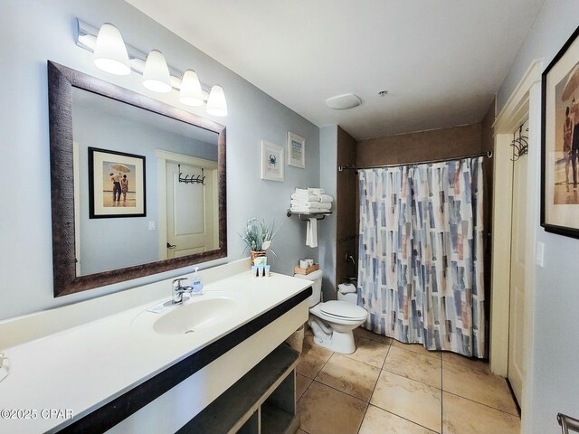 bathroom with tile patterned flooring, vanity, and toilet