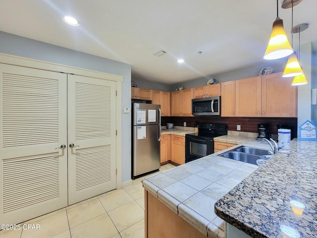 kitchen with hanging light fixtures, light tile patterned floors, stainless steel appliances, and sink