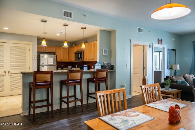 dining room with dark wood-type flooring