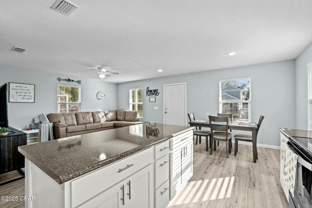3111 E 2nd Plz, Panama City, FL 32401 - kitchen with light wood finished floors, white cabinetry, ceiling fan, stainless steel electric stove, and recessed lighting