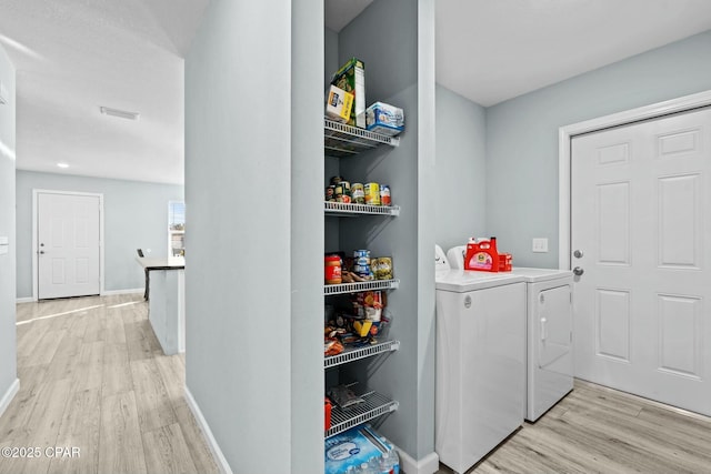 3111 E 2nd Plz, Panama City, FL 32401 - laundry room featuring washer and dryer, light wood-type flooring, and baseboards