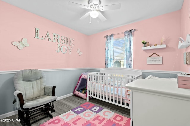 3111 E 2nd Plz, Panama City, FL 32401 - bedroom featuring wood finished floors, a nursery area, baseboards, and ceiling fan