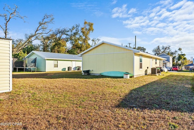 3111 E 2nd Plz, Panama City, FL 32401 - back of property featuring a trampoline, central AC unit, and a yard
