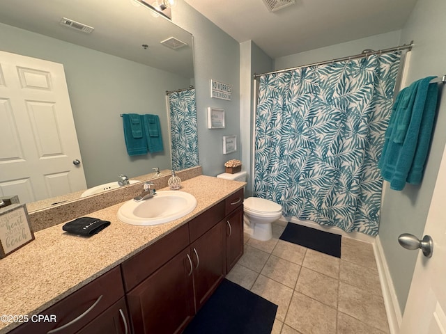 bathroom featuring tile patterned flooring, vanity, and toilet