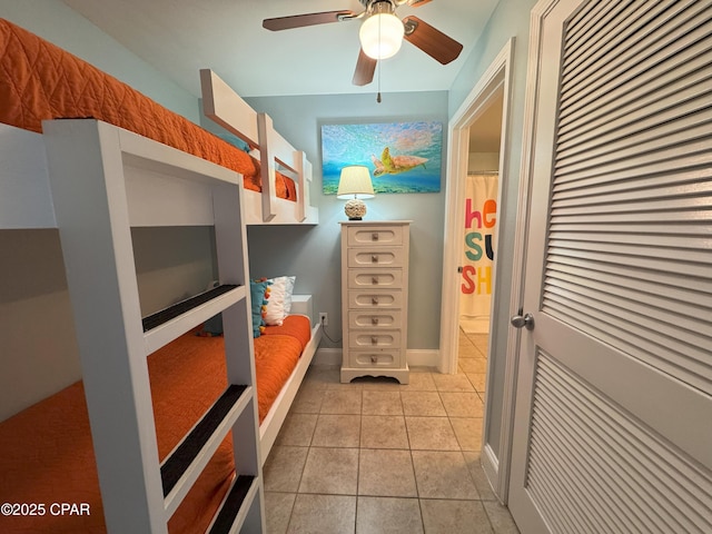 unfurnished bedroom with ceiling fan and light tile patterned floors