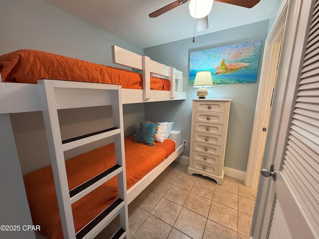 bedroom with ceiling fan and light tile patterned floors