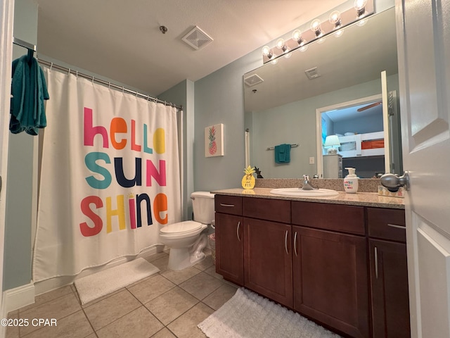 bathroom with tile patterned flooring, vanity, and toilet