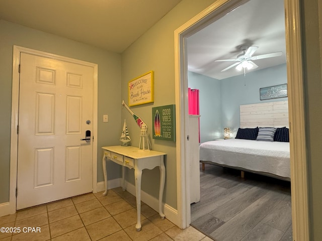 bedroom with tile patterned floors and ceiling fan