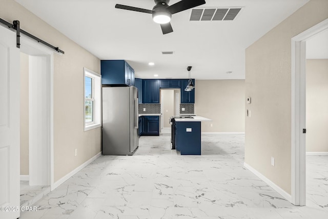 kitchen featuring stainless steel fridge, tasteful backsplash, blue cabinets, decorative light fixtures, and a breakfast bar area