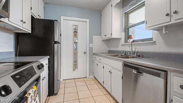 kitchen with stainless steel appliances, white cabinetry, sink, and decorative backsplash