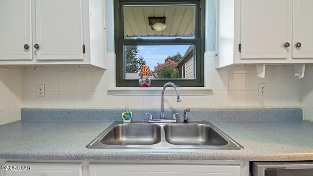 kitchen with white cabinetry, sink, decorative backsplash, and stainless steel dishwasher