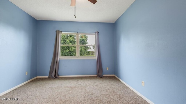 carpeted empty room with ceiling fan and a textured ceiling