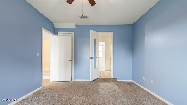 unfurnished bedroom with ceiling fan and carpet