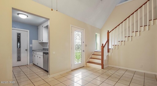 tiled entryway with vaulted ceiling