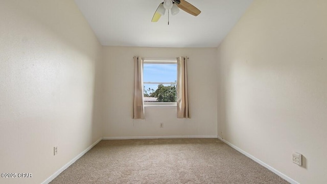 carpeted spare room with ceiling fan