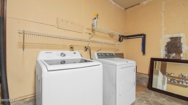 clothes washing area featuring independent washer and dryer