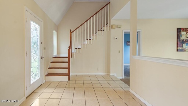 foyer with vaulted ceiling and light tile patterned flooring