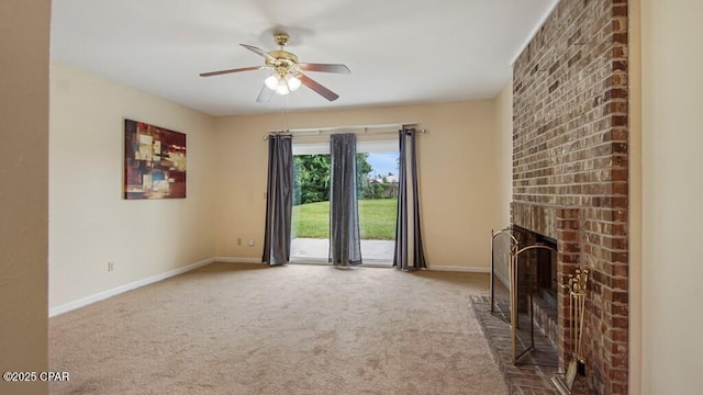 unfurnished living room featuring ceiling fan, carpet flooring, and a brick fireplace