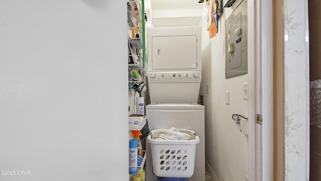 washroom featuring stacked washer / dryer