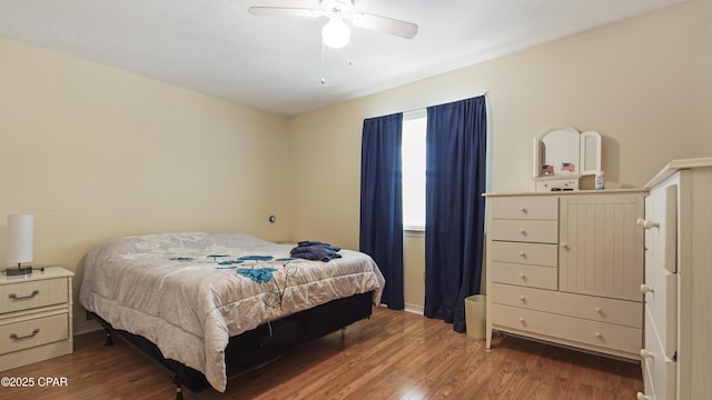 bedroom with dark wood-type flooring and ceiling fan