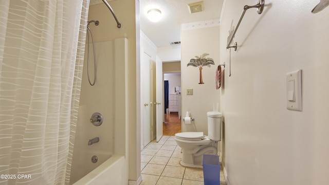 bathroom with shower / tub combo, tile patterned floors, a textured ceiling, and toilet