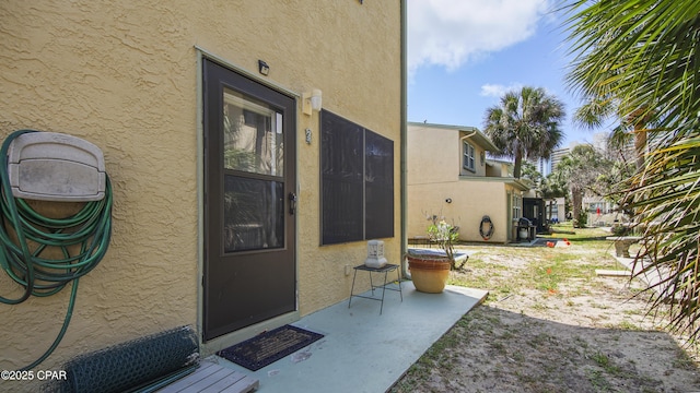 property entrance featuring a patio area