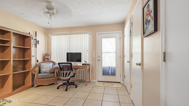 tiled home office featuring ceiling fan and a textured ceiling