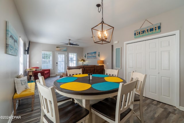 dining room featuring dark wood-type flooring and ceiling fan with notable chandelier