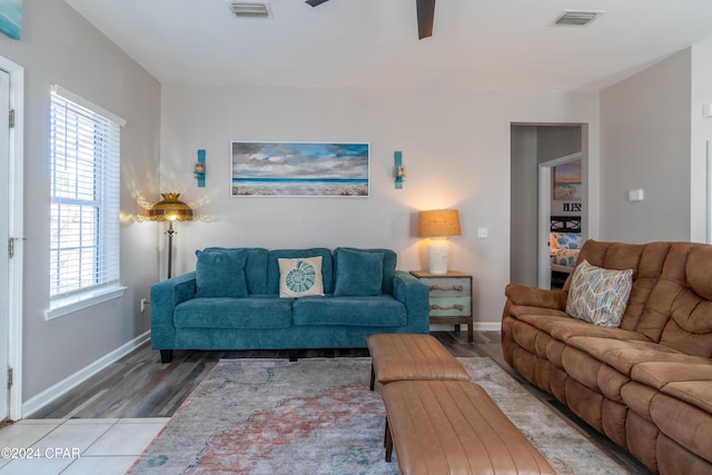 living room featuring hardwood / wood-style flooring, ceiling fan, and a healthy amount of sunlight