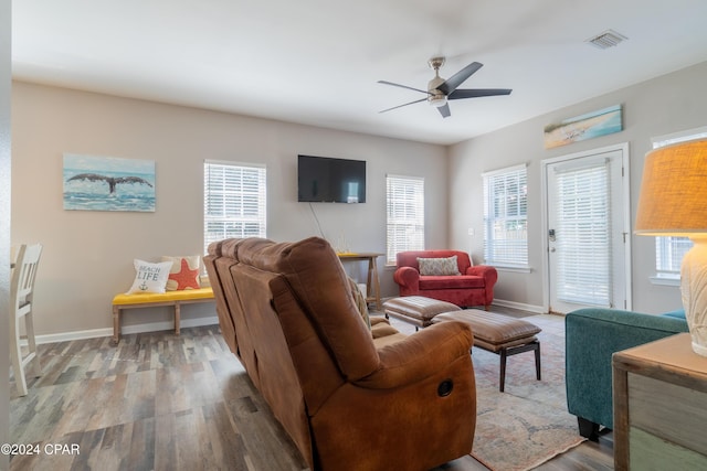 living room featuring hardwood / wood-style floors and ceiling fan