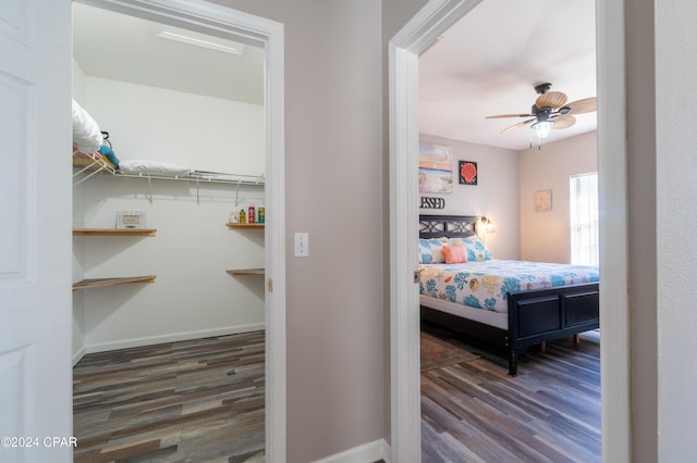 bedroom with dark wood-type flooring and ceiling fan