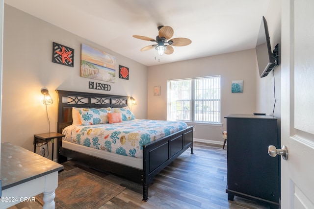 bedroom with dark hardwood / wood-style floors and ceiling fan