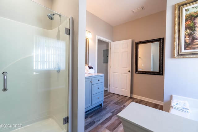 bathroom featuring vanity, an enclosed shower, and hardwood / wood-style floors